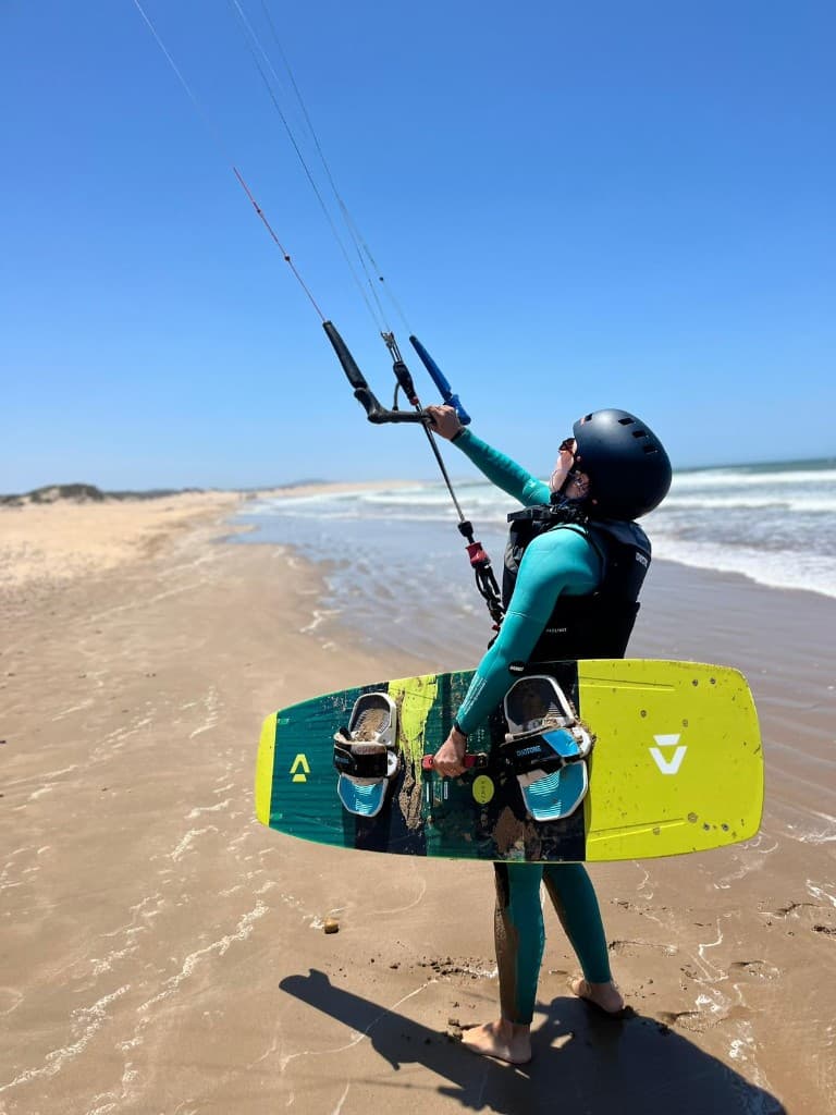 Kitesurf school Essaouira — group on the beach preparing kites and harnesses with instructors