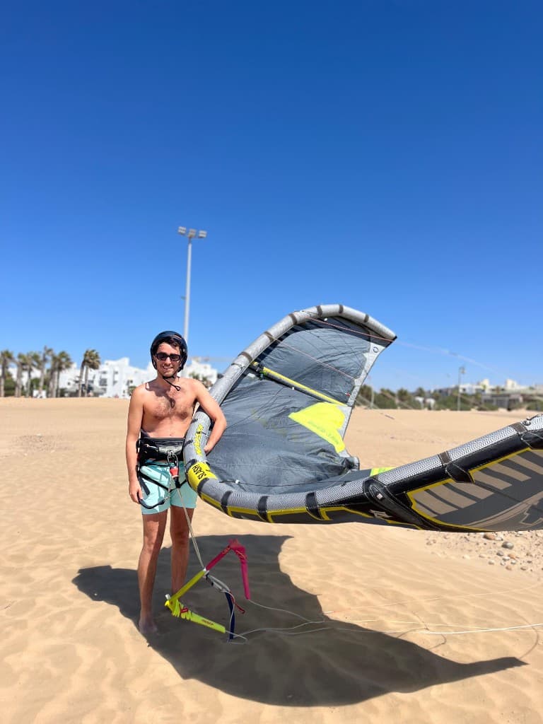 Kitesurfing session in Essaouira — rider with harness and kite on the beach