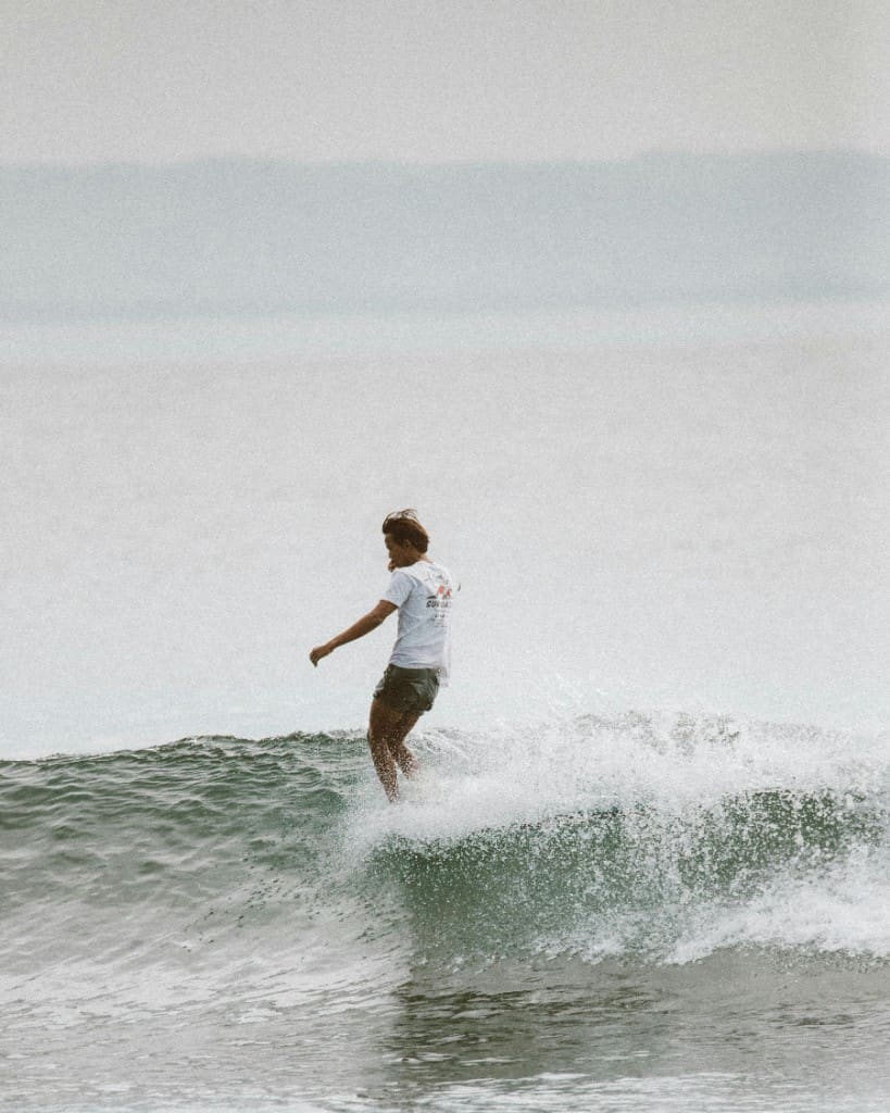Surfer on a wave off the Essaouira coast, Morocco