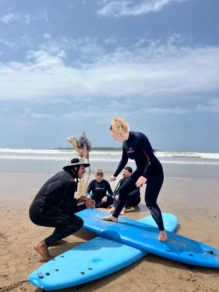 Surf instructor coaching beginner on Essaouira beach